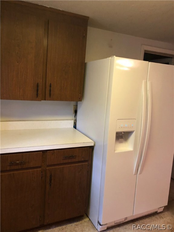 Kitchen with newer side by side refrigerator.