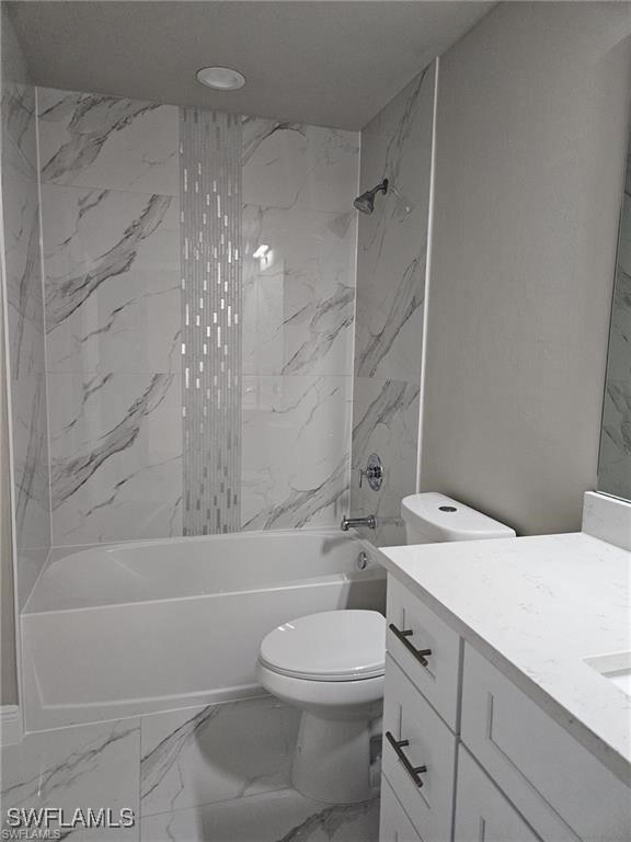 Full bathroom with vanity, toilet, and tiled showe