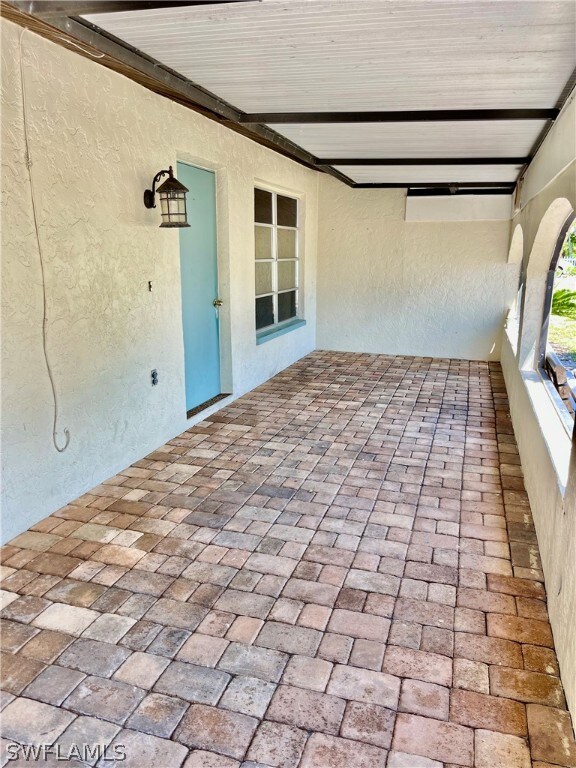 Detailed paved covered front entrance.