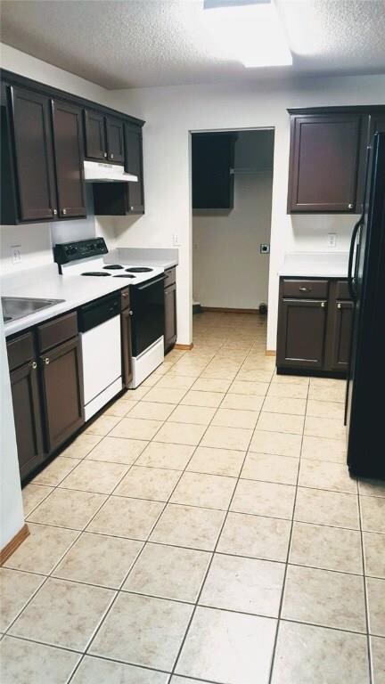 Freshly painted cabinets, ample counter space, and a refrigerator to convey