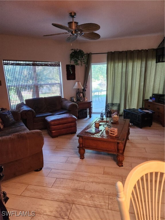 Living area with wood-type flooring and a ceiling