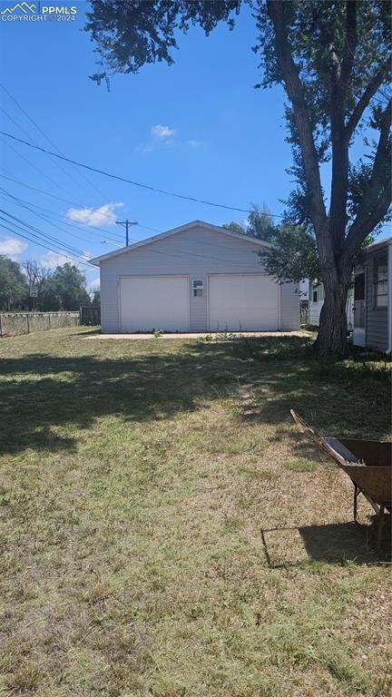 View of yard with a garage that is oversized.  2 o