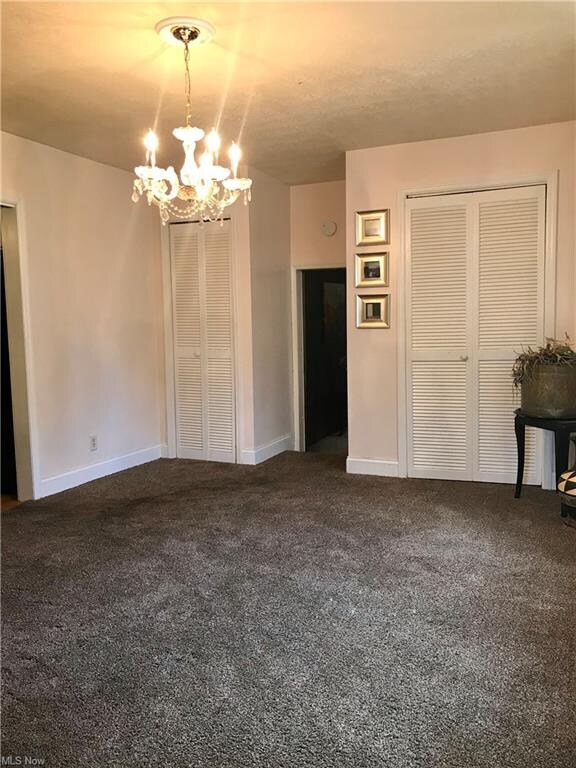 Spacious formal dining room features carpet, large