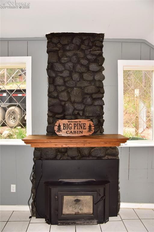 Detailed view of a wood stove and a decorative wall