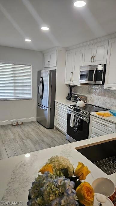 Kitchen featuring backsplash, recessed lighting, a