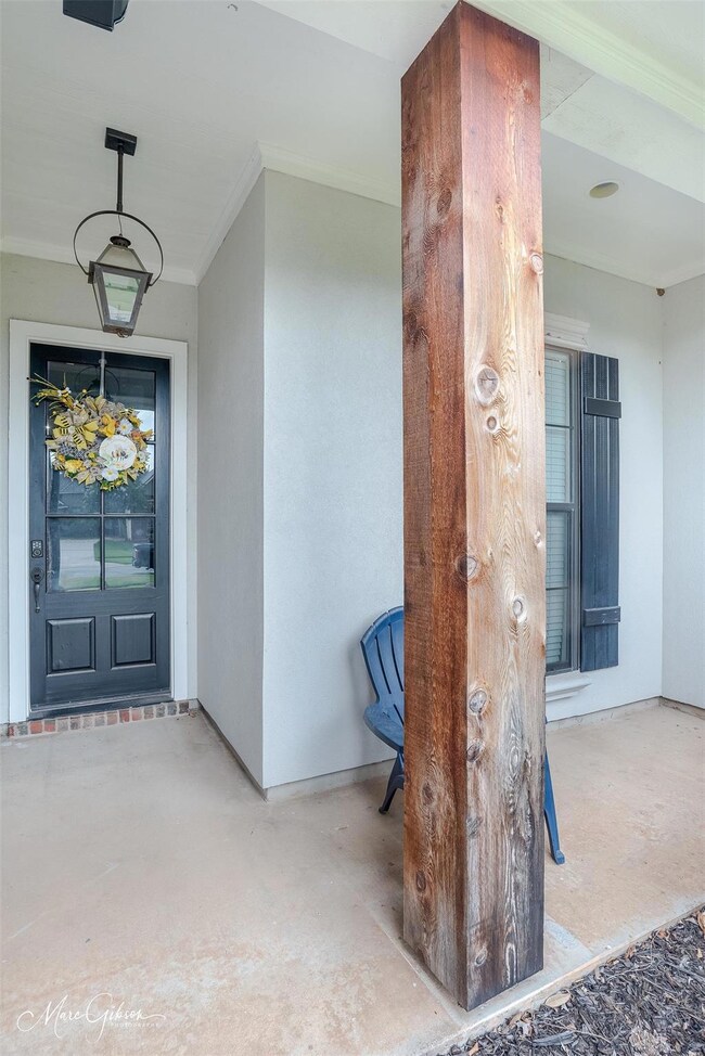 Doorway to property with covered porch