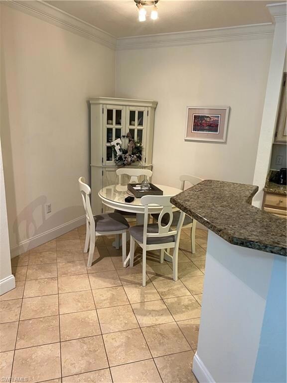 Dining space featuring baseboards, crown molding, 