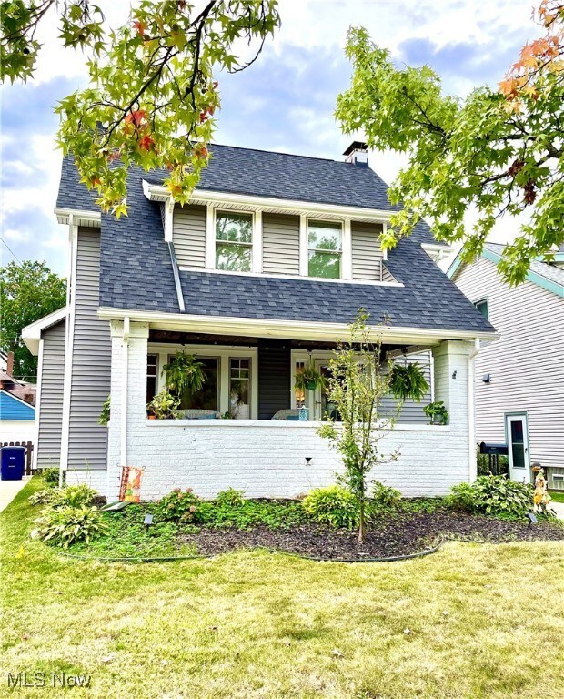 View of front of home featuring  a cozy quaint covered porch, new roof and siding