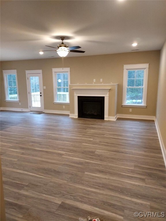 Unfurnished living room with dark hardwood / wood-