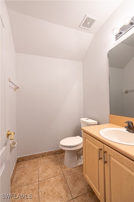 Half bath with vanity, lofted ceiling, and tile pa