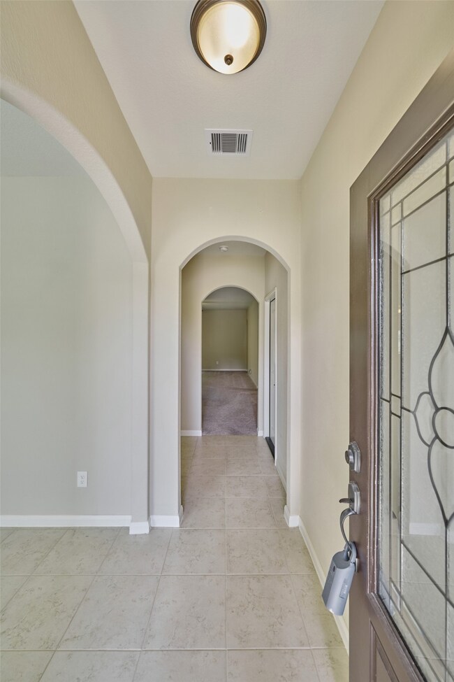 Attactive entry with high ceilings and beautiful front door.