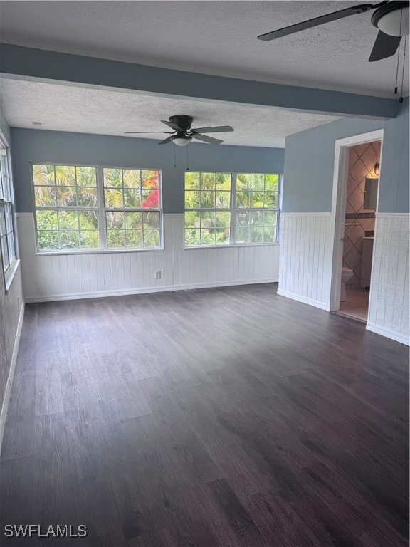 Empty room featuring a ceiling fan, a textured cei