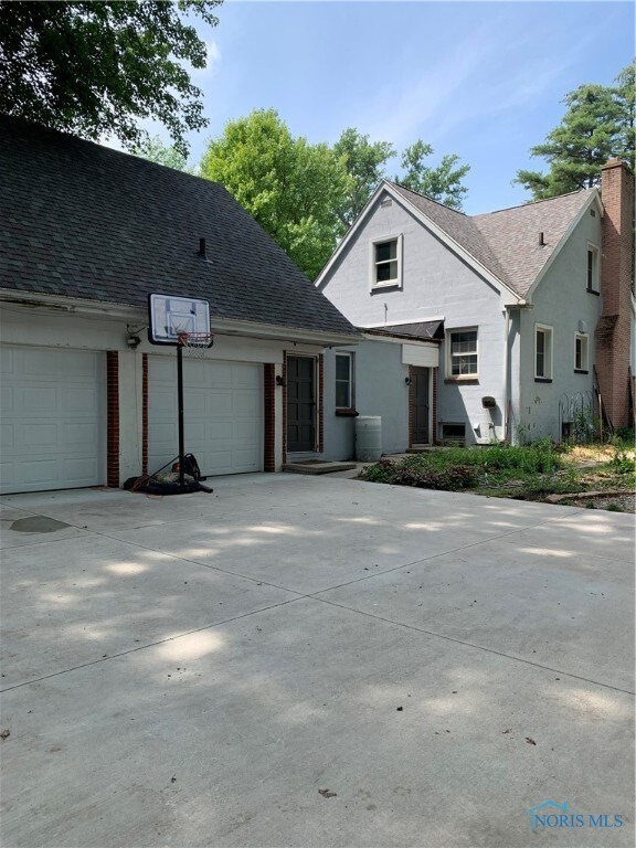 Exterior side view of house and attached garage