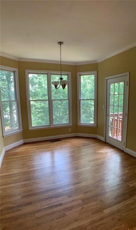 Unfurnished dining area with crown molding and light wood-style flooring