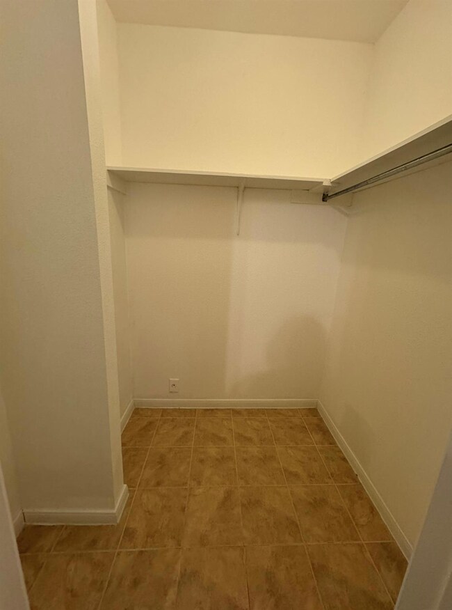 Walk in closet featuring tile patterned flooring