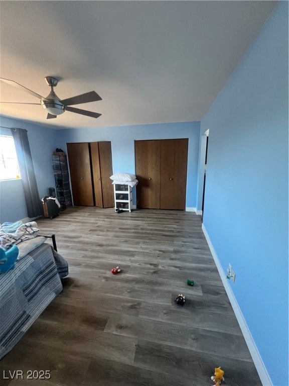 Bedroom featuring multiple closets, baseboards, ce