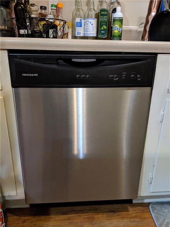 Detailed view of dishwasher, wood finished floors