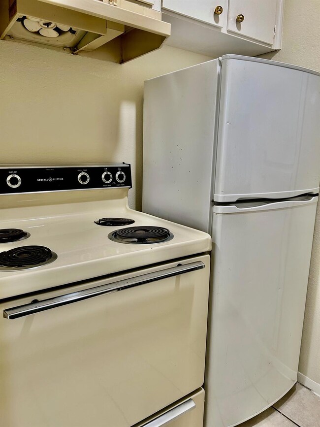 Kitchen featuring white appliances, white cabinet