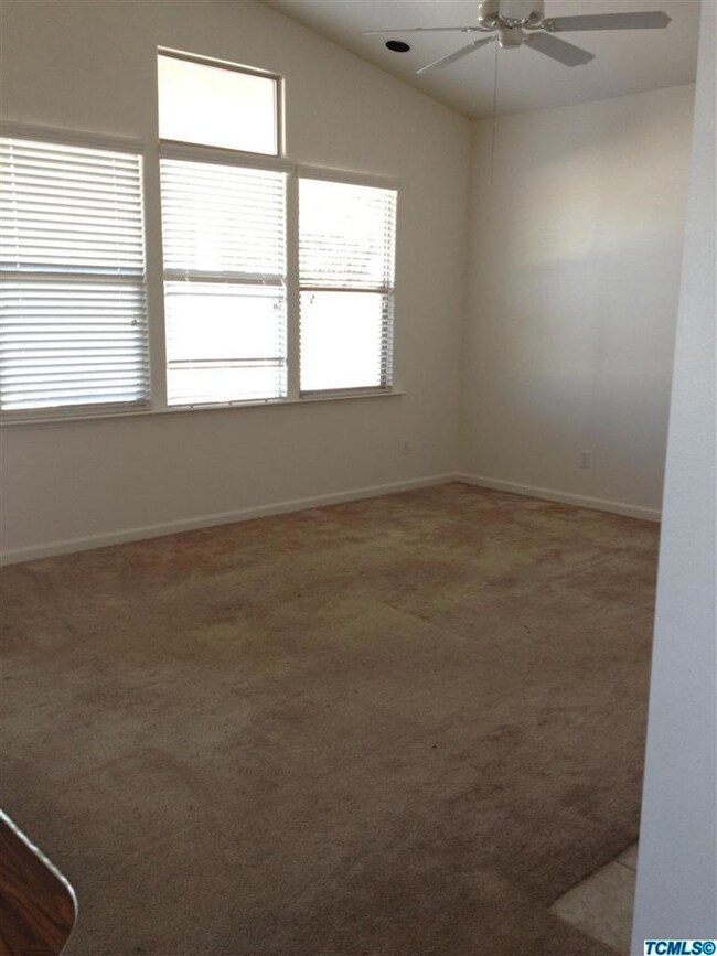 Living room, windows look out to covered