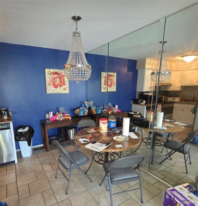 Dining space with a chandelier and light tile patterned floors