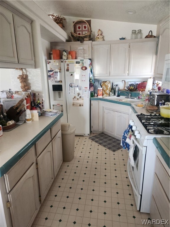 Kitchen featuring refrigerator, gas range oven, wh
