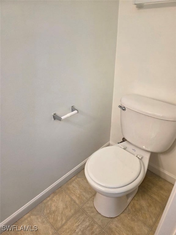Bathroom with baseboards and tile patterned floors