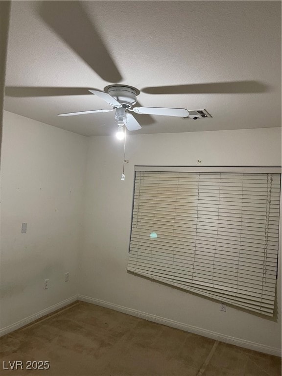 Empty room with ceiling fan and baseboards