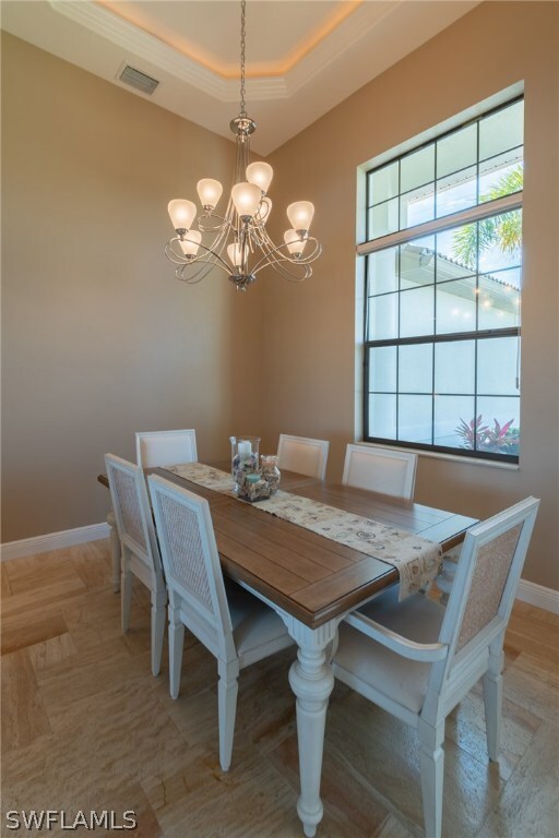 A formal dining room with a tray ceiling.