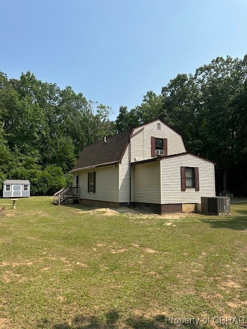 View of home's exterior with a yard, central AC, a
