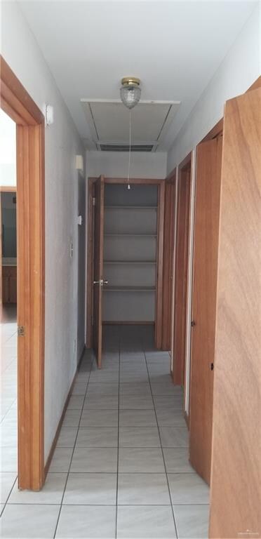 Hallway with light tile floors