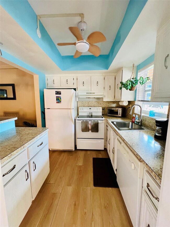 All white cabinets kitchen with all white applianc
