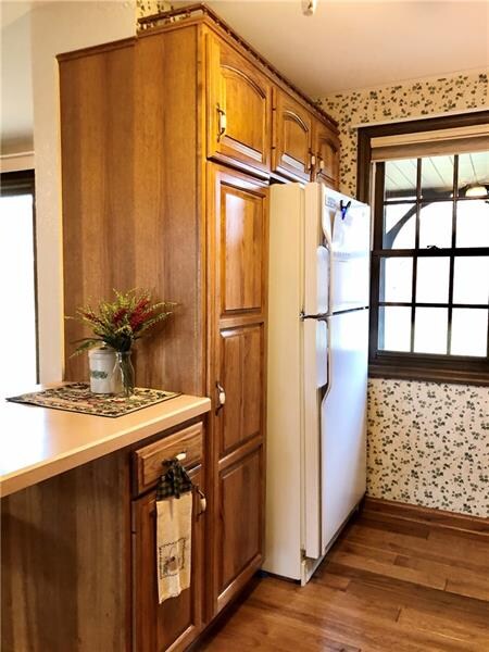 Extra cabinets and a vertical pantry to the left o