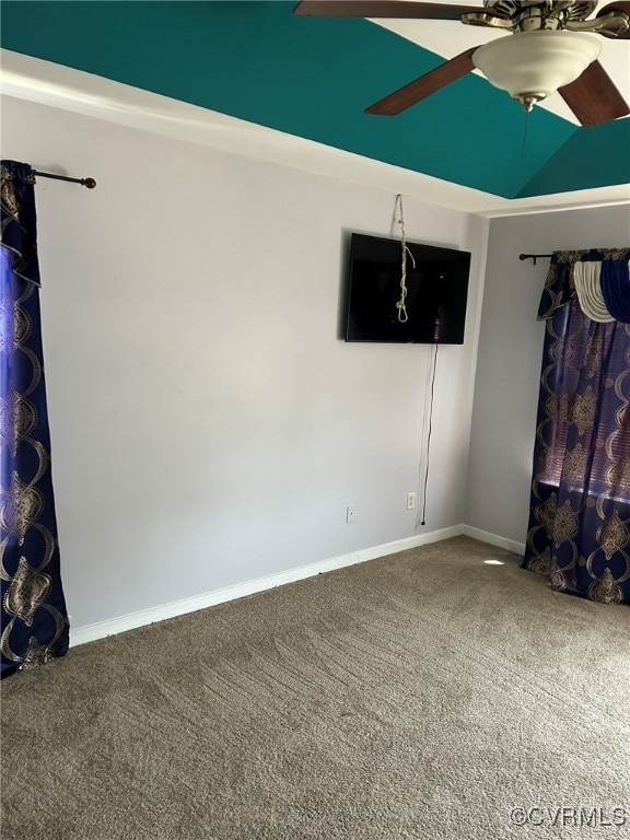 Carpeted spare room with ceiling fan and baseboard
