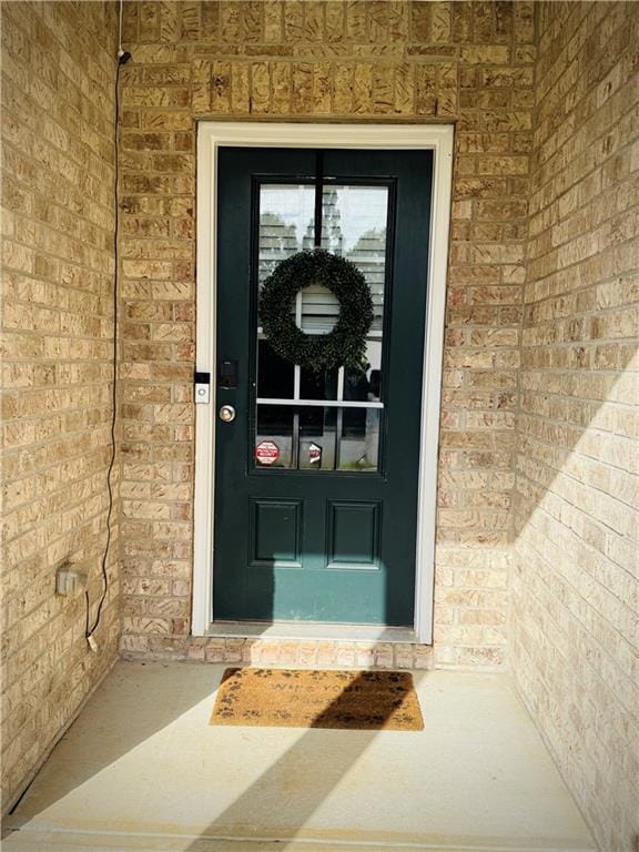 Property entrance featuring brick siding