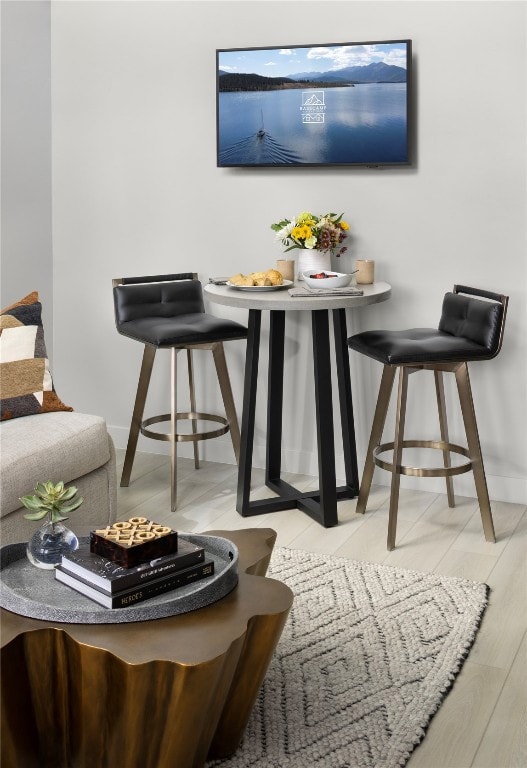 Dining area with light wood-style floors and baseboards