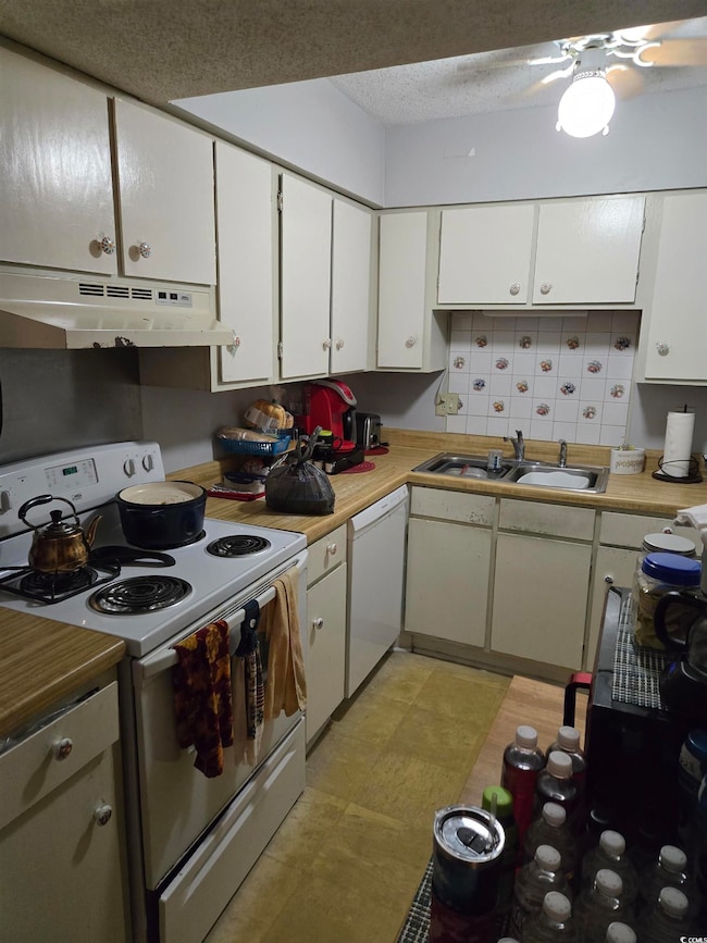 Kitchen featuring white appliances, under cabinet 
