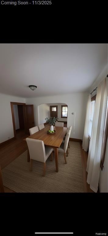 Bedroom featuring dark wood-style flooring and baseboards