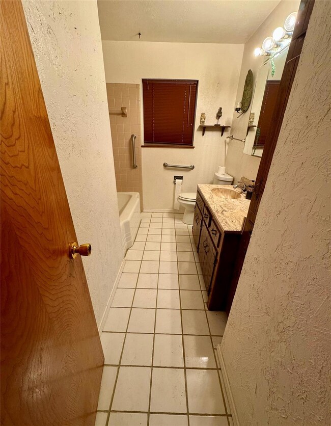 Bathroom tub combo with tile floors