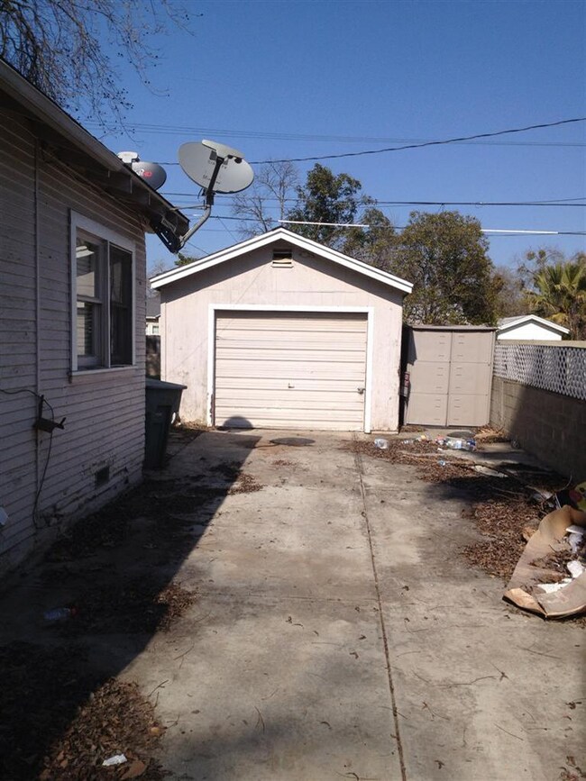 between gate and rear garage, large cement area, p