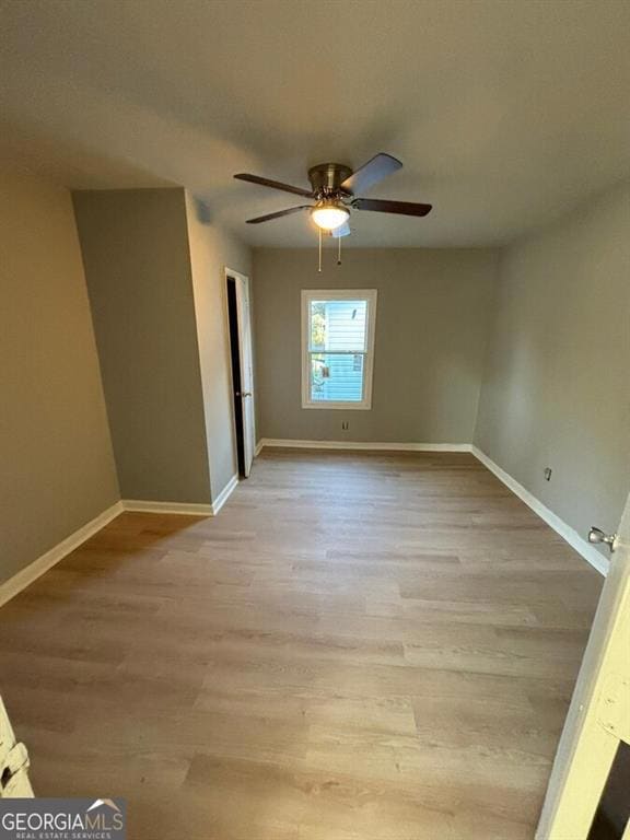 Unfurnished room featuring light wood finished floors and a ceiling fan