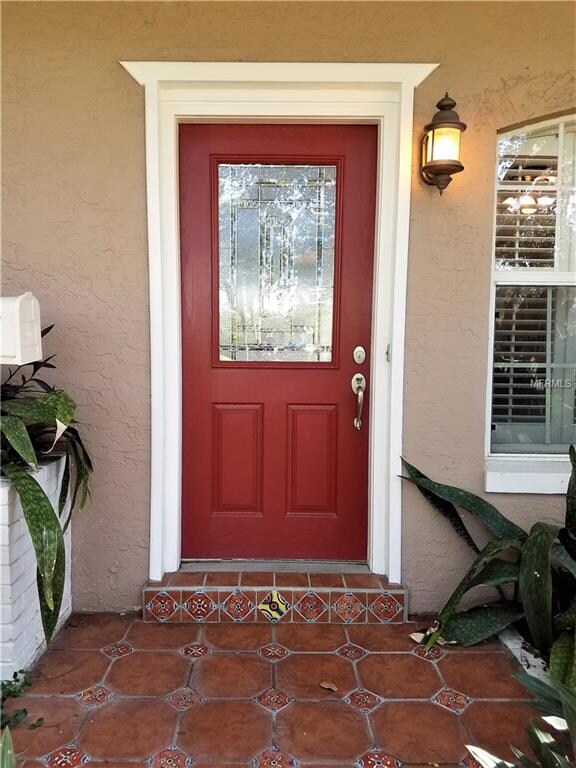 A gorgeous red front door and Mexican tile landing