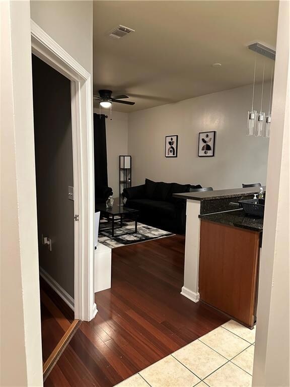 Corridor with light hardwood / wood-style flooring