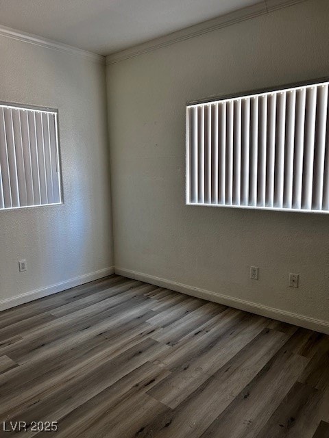 Unfurnished room with crown molding, wood finished