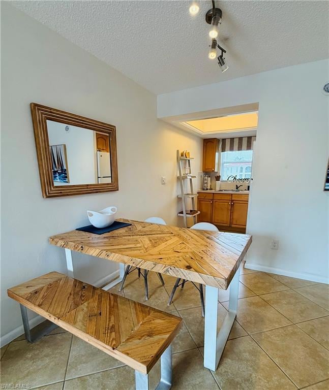 Dining space featuring light tile patterned floors