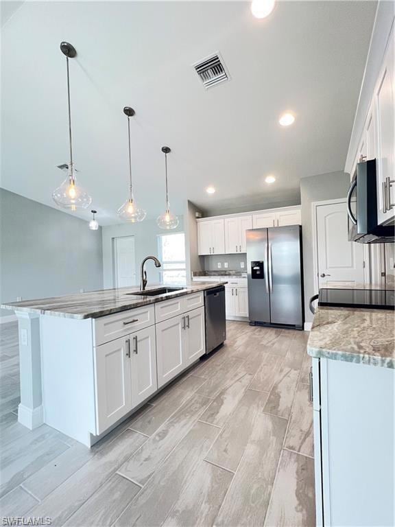 Kitchen featuring sink, light hardwood / wood-styl