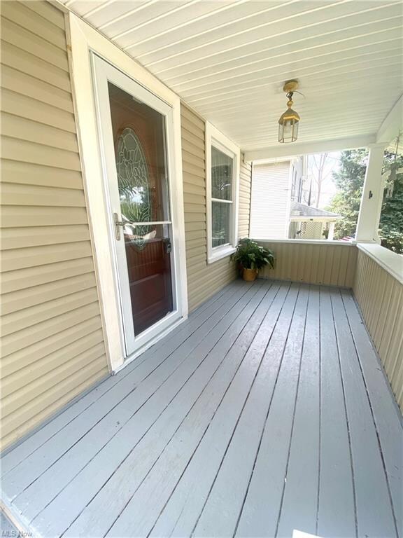 PORCH WITH FRESH PAINT AND STORM DOOR.