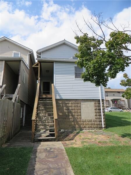 Exterior rear with steps to main level