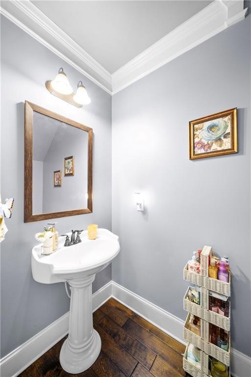 Bathroom with crown molding and hardwood / wood-style floors