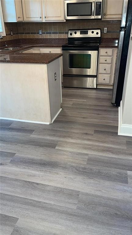 Kitchen featuring dark countertops, dark wood fini