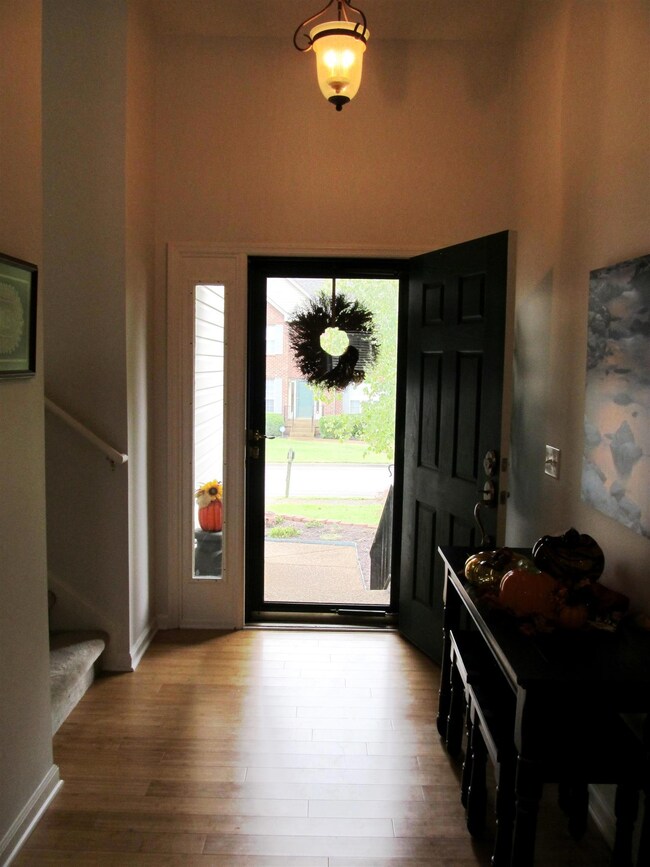 entry foyer looking from LR, kitchen doorway on left & steps to Bonus.